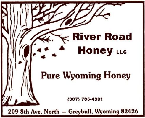 The River Road Honey LLC label: a drawn tree with a swarm of bees, “Pure Wyoming Honey”